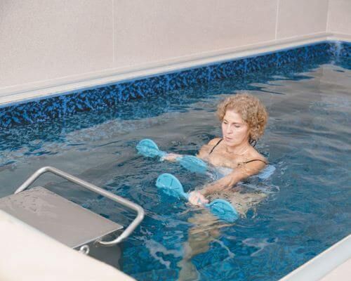 Idamarie Duffy performs aquatic exercise in her Endless Pools therapy pool