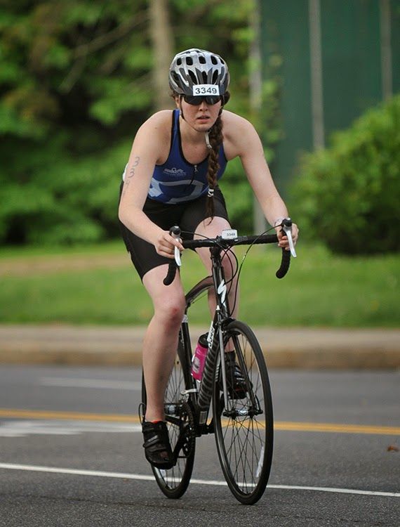 a member of Team Endless Pools cycling at the TriRock Philly triathlon