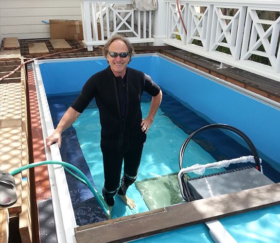 A technician in a pool installation