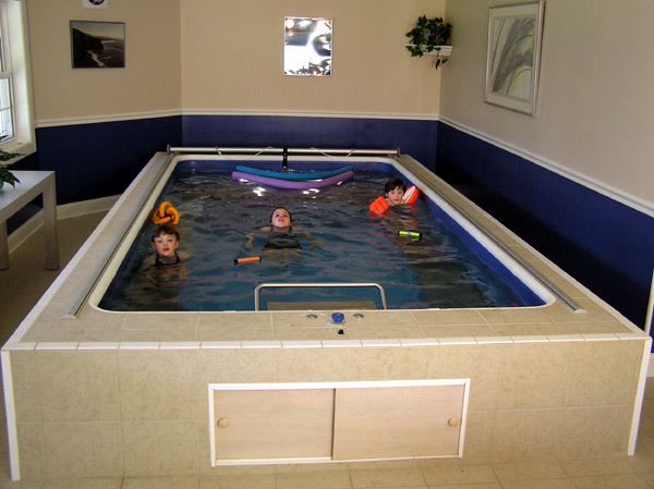 children play in an Endless Pools swimming machine