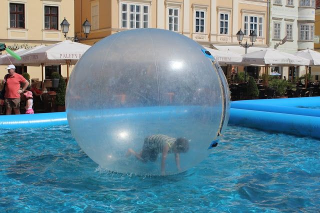 a boy in a bubble in a swimming pool