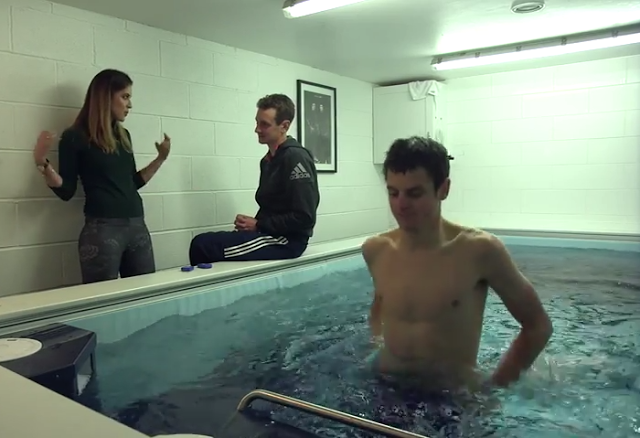 Olympic triathlete Jonathan Brownless trains on the Endless Pools Underwater Treadmill while Alistair Brownless gets interviewed