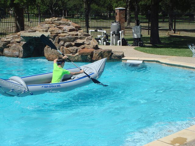 a kayaker paddles in place with the Endless Pools Fastlane current
