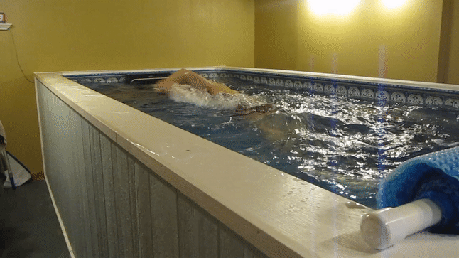 Mike swims in the Original Endless Pool in his basement in Dubuque, Iowa