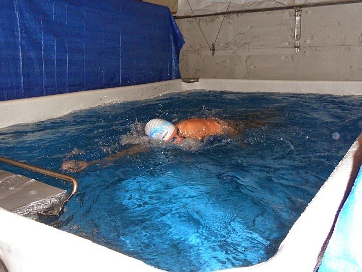 Marathon swimmer Katie Benoit training in the Endless Pools swimming machine in her garage