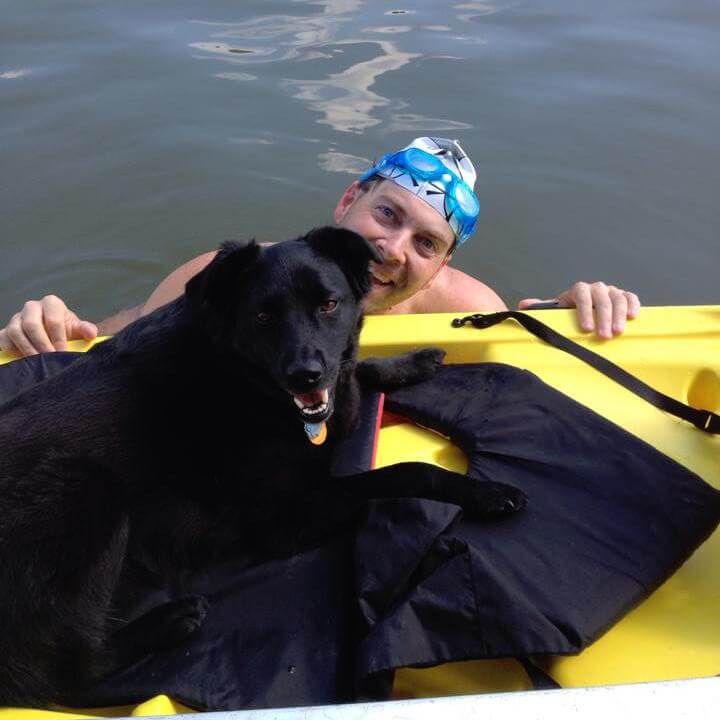 picture of paratriathlete Chris with his dog after an open water swim