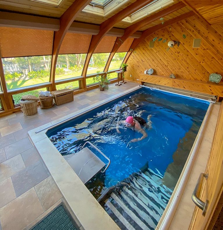 Picture of a customer swimming in her indoor fitness pool