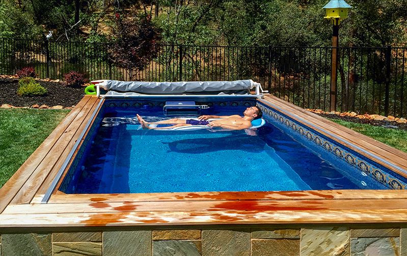 picture of a man relaxes in his Endless Pools&reg; Original model