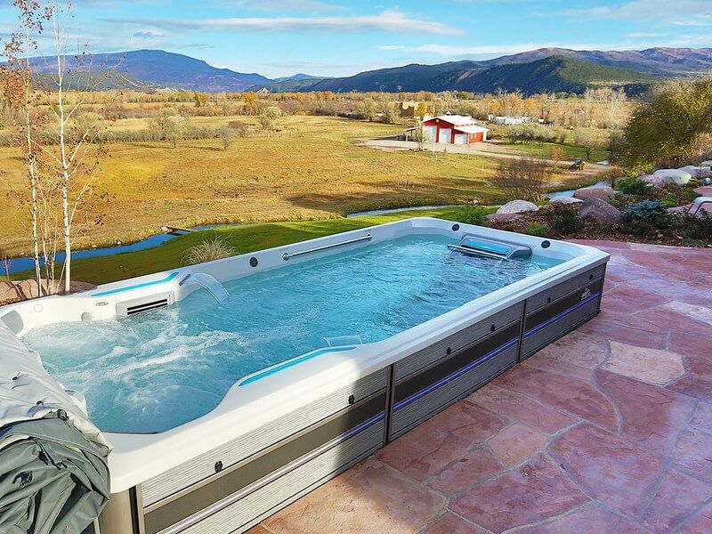 picture of an Endless Pools Fitness System E700 17-foot swim spa installed partially in-ground