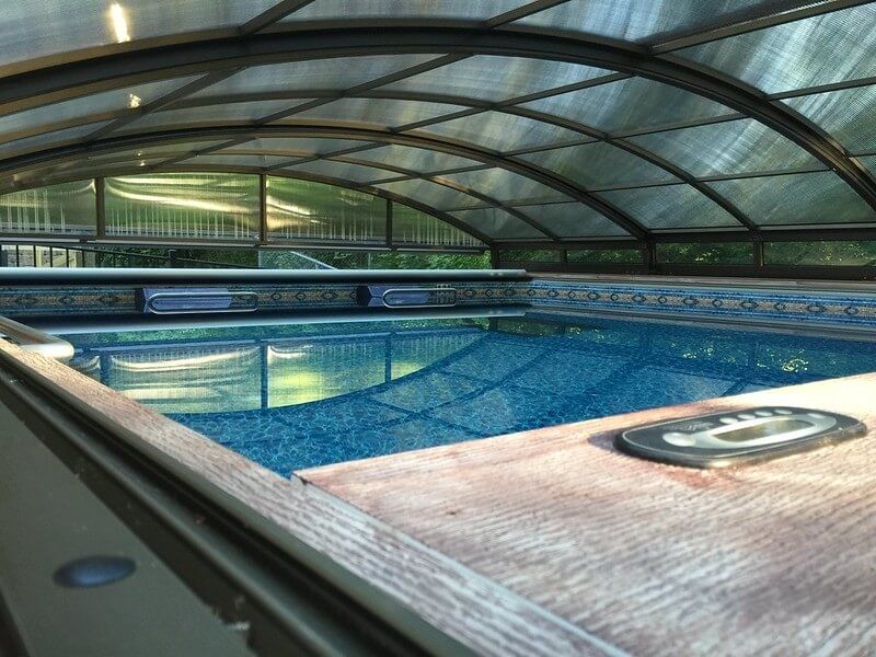 picture of Endless Pools Dual Propulsion model under a telescopic pool enclosure
