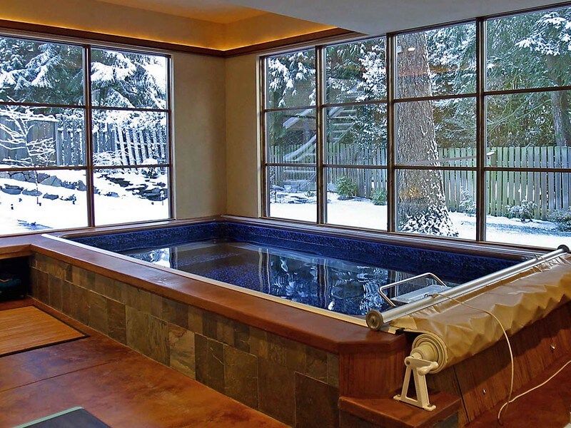 picture of partially in-ground Endless Pools Performance pool in a sunroom in winter