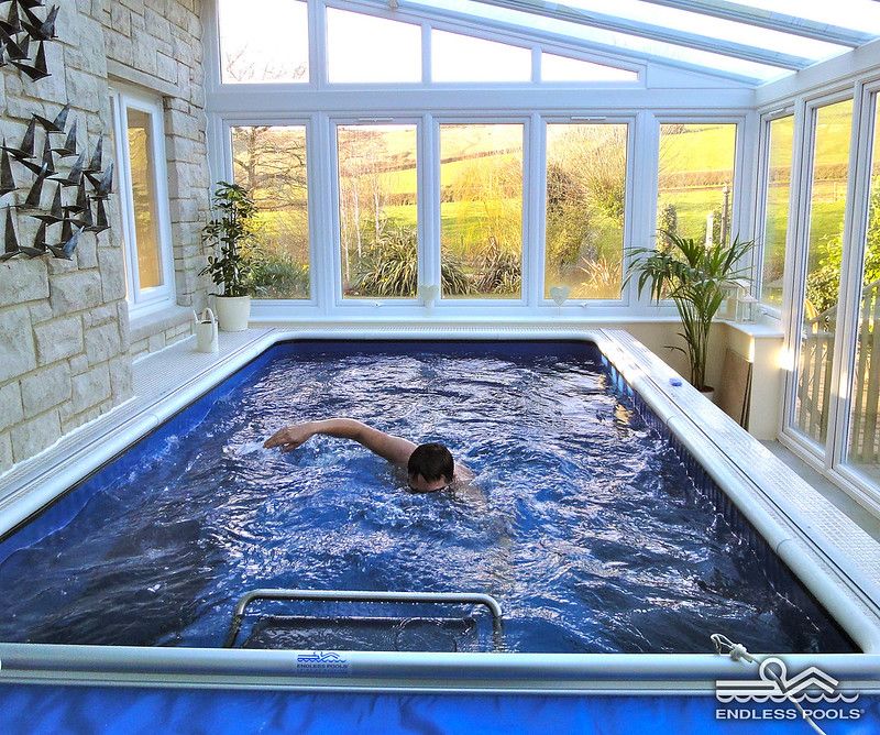 picture of swimmer using the Endless Pools swim current in an indoor swimming pool