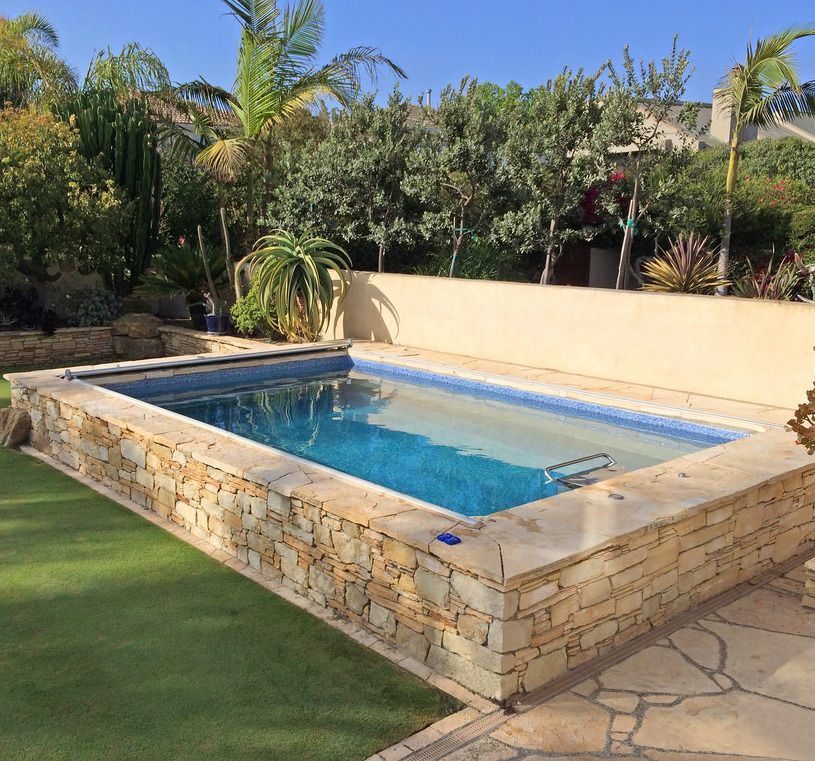 picture of an Endless Pools Original model installed as a partially in-ground backyard pool