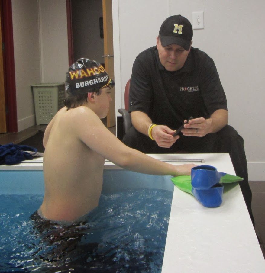 Coach Hutchinson discussing swim technique with a Jersey Wahoo swimmer