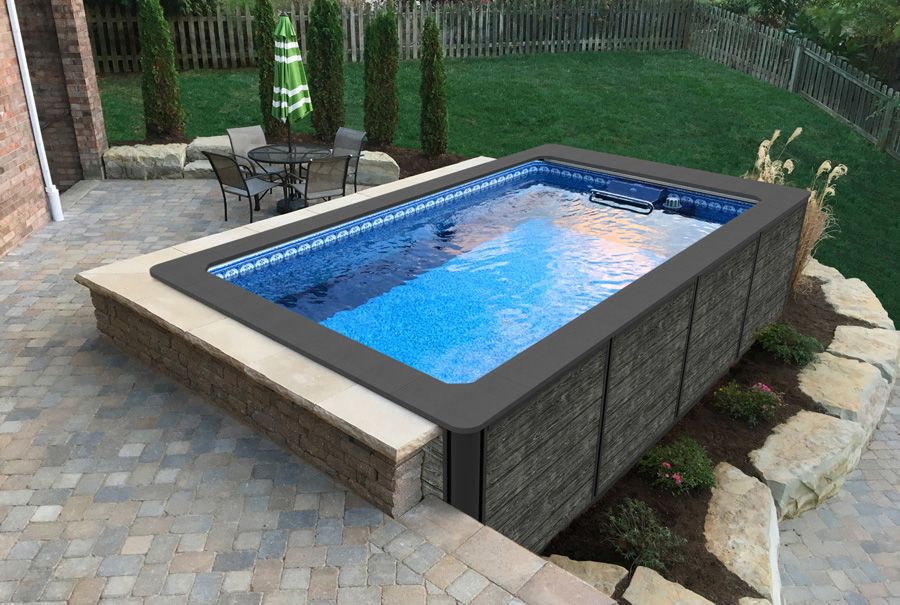 A picture of aboveground backyard pool with Endless Pools skirting and coping