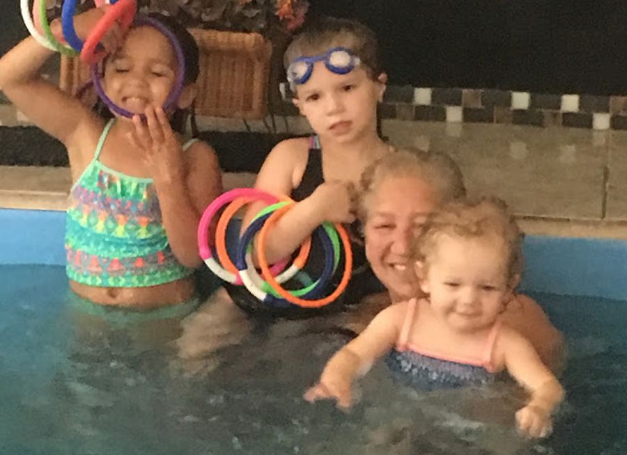 picture of Linda and her granddaughters in her indoor Endless Pools Original pool