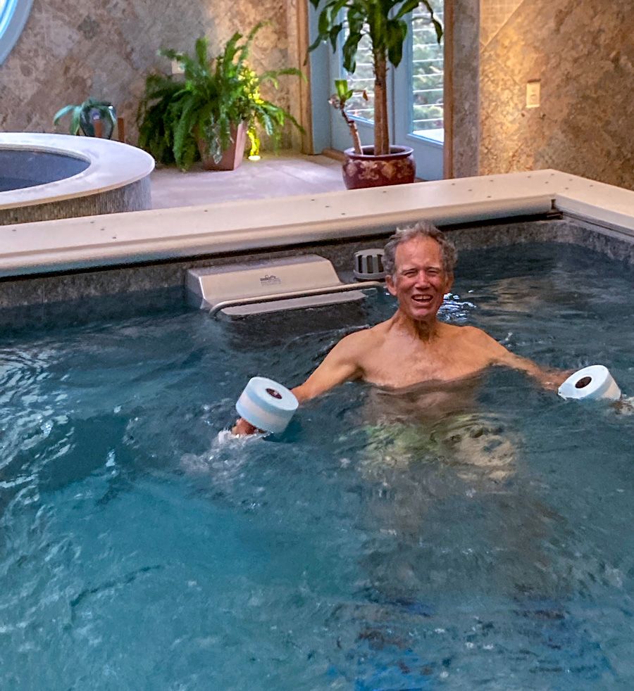 picture of a pool therapy workout with aquatic dumbbells in an Endless Pools Dual Propulsion pool