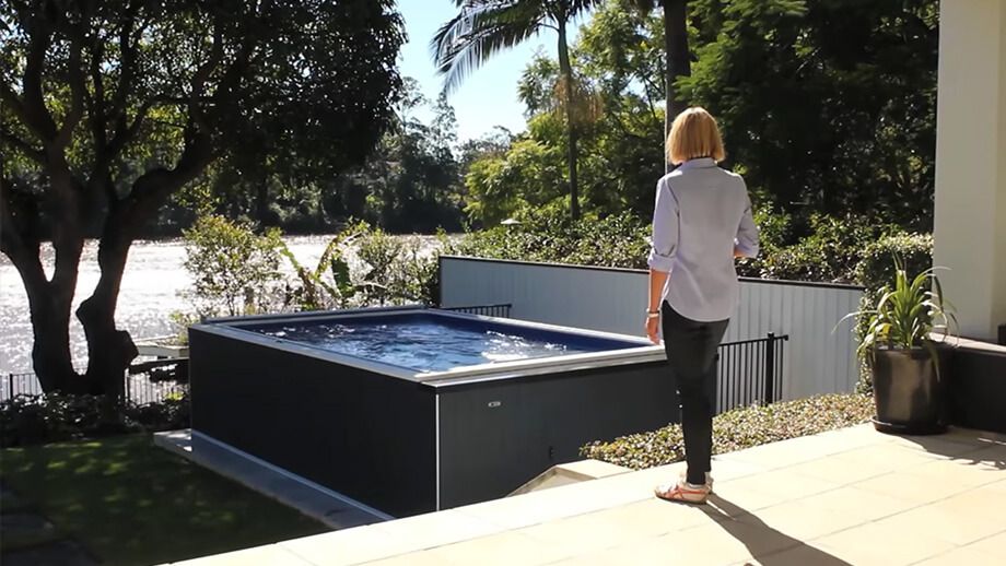 Picture of a customer looking into her backyard Endless Pools Elite model