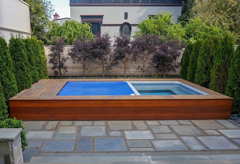 Picture of partially inground pool with an automatic retractable security cover