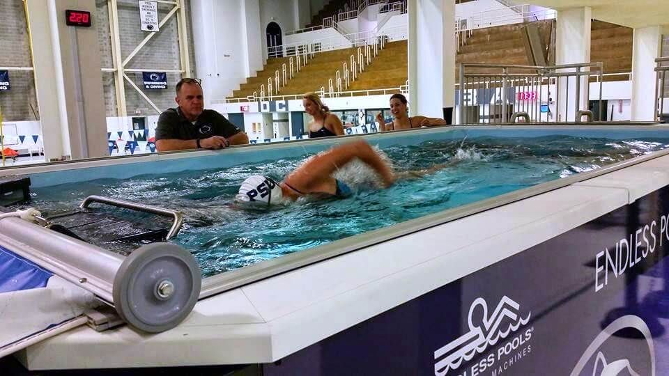 Swimming coach Tim Murphy training a swimmer in the Elite Endless Pool at Penn State
