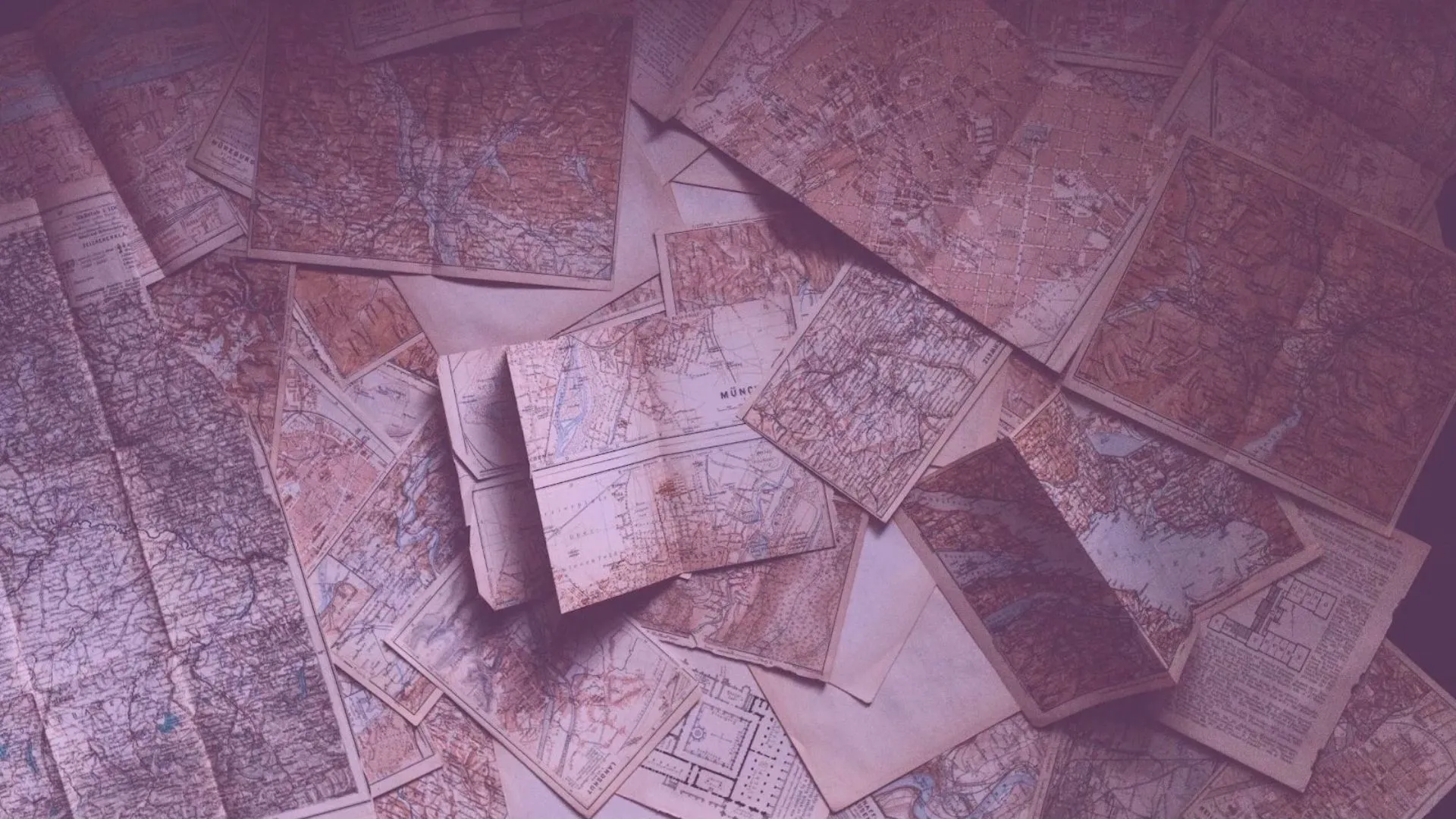 Old maps on a table representing product roadmaps