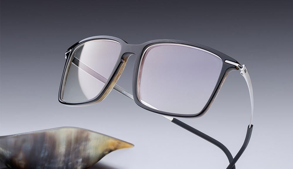 horn eyewear with a dark horn front and white gold temples