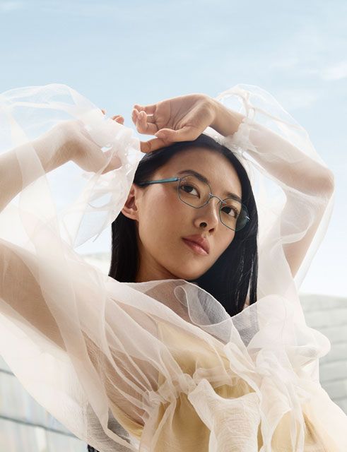 Close-up of the Pure Visionary eyewear frame highlighting the ultra-thin titanium profile wire, angular bridge design, and adjustable transparent nose pads in a sleek dark finish.