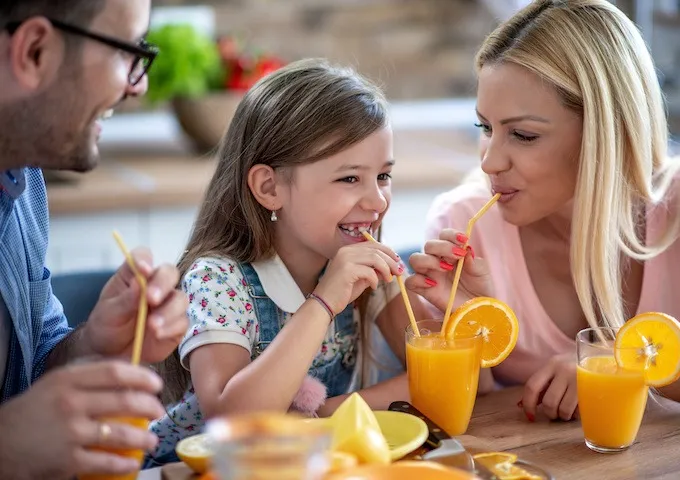A happy family enjoying Welch's orange juice.